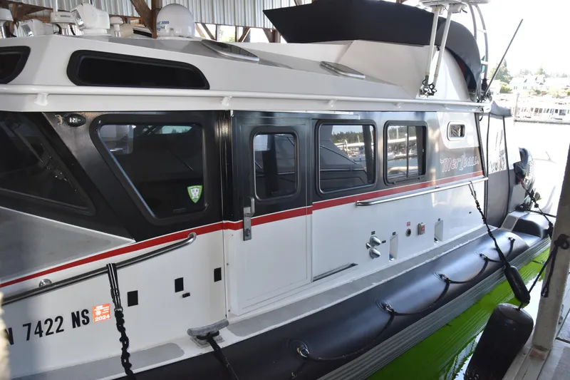 Slide: The Image of 2005 SAFE Boats 33 Full Cabin docked, featuring sleek design and modern equipment. - 16