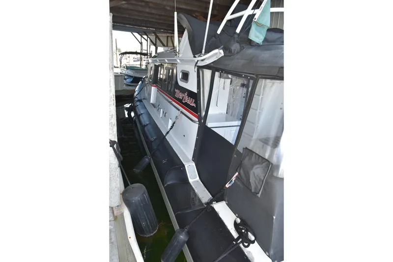 Slide: The Image of 2005 SAFE Boats 33 Full Cabin docked under shelter. - 18