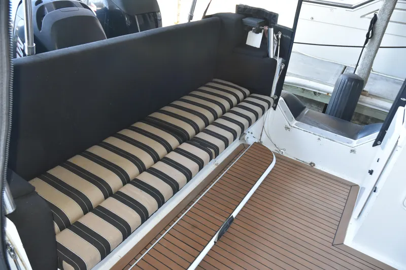 Slide: The Image of Interior of 2005 SAFE Boats 33 Full Cabin with striped seating and wood-patterned flooring. - 20
