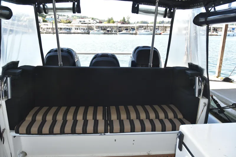 Slide: The Image of Interior view of 2005 SAFE Boats 33 Full Cabin with striped seating and outboard motors. - 23