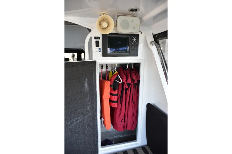 Slide: The Image of Interior of 2005 SAFE Boats 33 Full Cabin with life jackets and navigation equipment. - 26