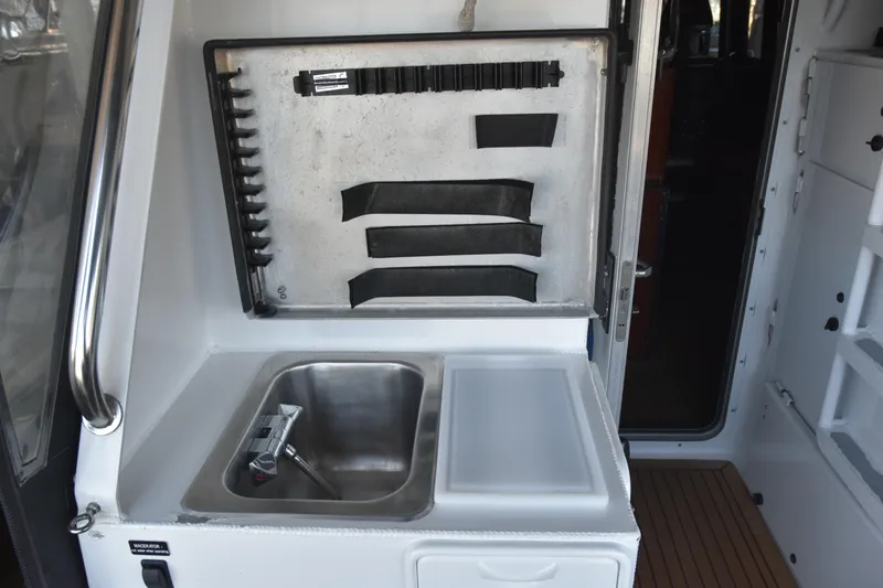 Slide: The Image of 2005 SAFE Boats 33 Full Cabin interior with sink and storage area. - 28