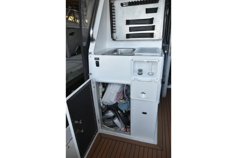 Slide: The Image of Interior view of a 2005 SAFE Boats 33 Full Cabin, featuring a compact sink and storage area. - 29