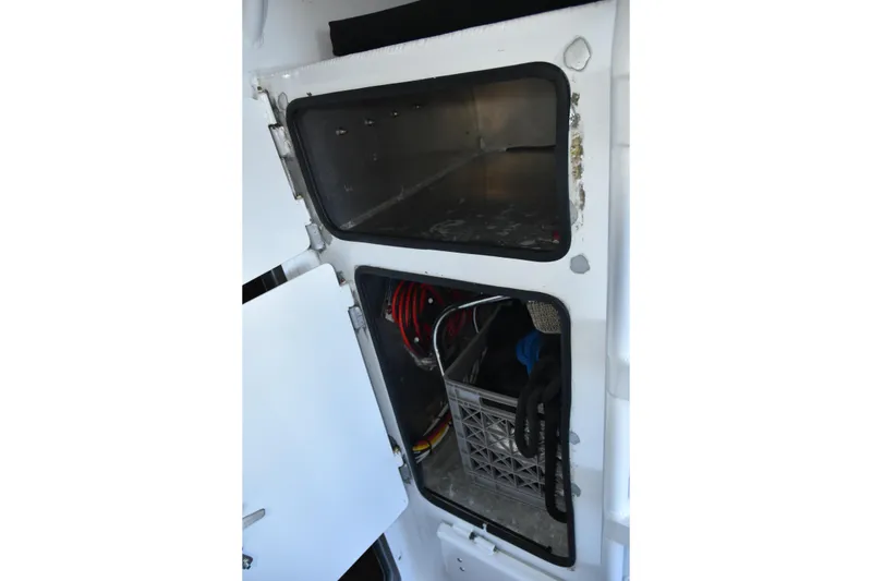Slide: The Image of Storage compartment inside a 2005 SAFE Boats 33 Full Cabin, featuring organized equipment. - 30