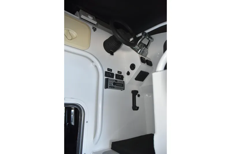 Slide: The Image of 2005 SAFE Boats 33 Full Cabin interior dashboard with steering wheel and controls. - 31