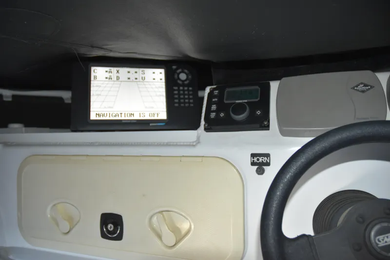 Slide: The Image of 2005 SAFE Boats 33 Full Cabin dashboard with navigation system and steering wheel. - 32