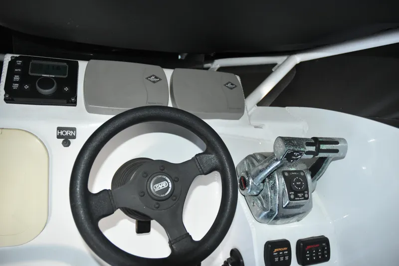 Slide: The Image of 2005 SAFE Boats 33 Full Cabin helm with steering wheel and control panel. - 33