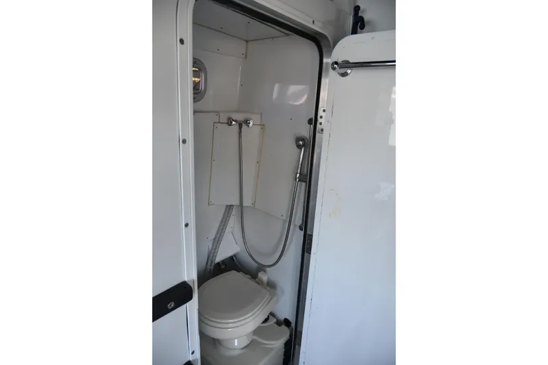 Slide: The Image of Compact bathroom inside 2005 SAFE Boats 33 Full Cabin, featuring toilet and shower. - 37