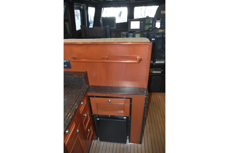 Slide: The Image of Interior of 2005 SAFE Boats 33 Full Cabin with wood cabinetry and navigation equipment. - 41