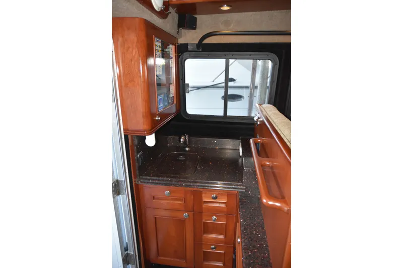 Slide: The Image of 2005 SAFE Boats 33 Full Cabin interior with wooden cabinetry and countertop. - 42