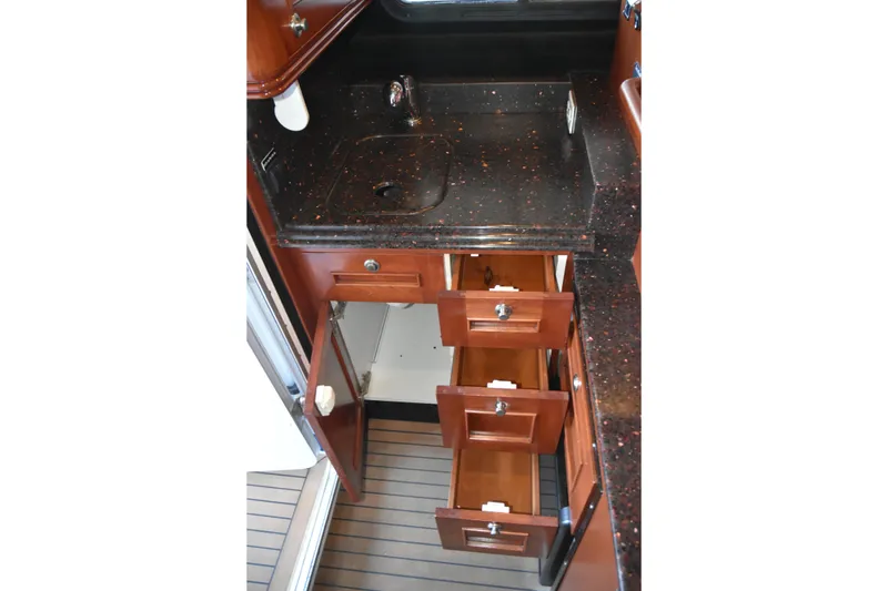 Slide: The Image of Interior of 2005 SAFE Boats 33 Full Cabin with open drawers and countertop sink. - 44