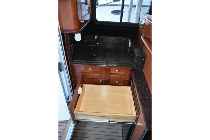 Slide: The Image of 2005 SAFE Boats 33 Full Cabin interior with sink, countertop, and open drawer. - 45