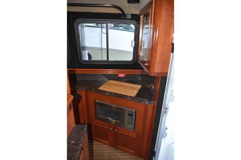 Slide: The Image of Interior of 2005 SAFE Boats 33 Full Cabin with kitchenette and window view. - 46