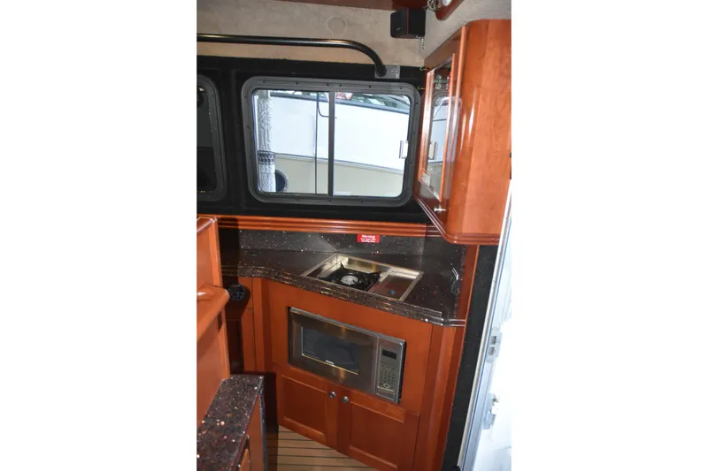 Slide: The Image of Interior of 2005 SAFE Boats 33 Full Cabin with kitchenette and wood cabinetry. - 47