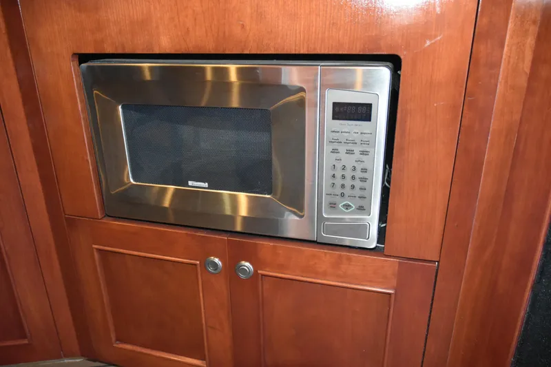 Slide: The Image of Built-in microwave in 2005 SAFE Boats 33 Full Cabin with wooden cabinetry. - 48
