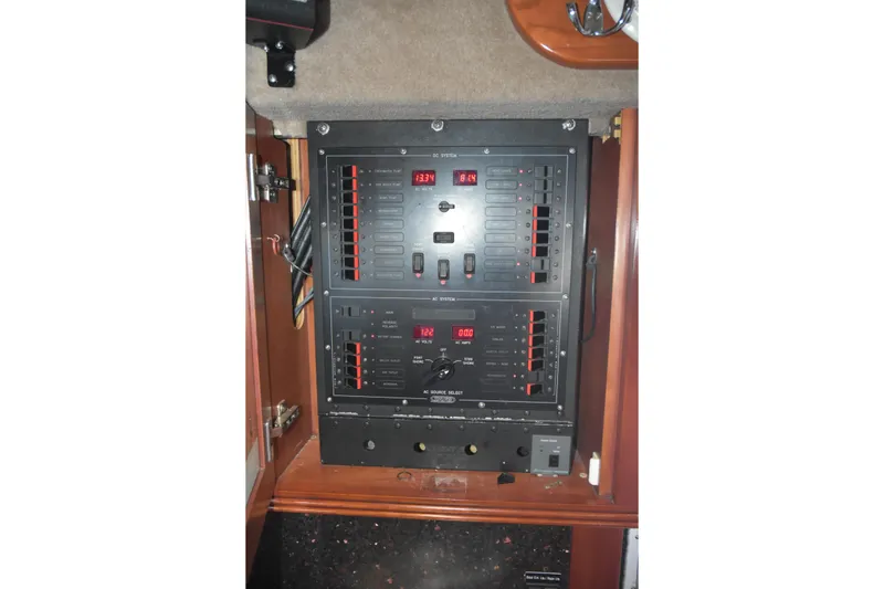 Slide: The Image of Electrical panel inside 2005 SAFE Boats 33 Full Cabin, showcasing control systems and switches. - 49