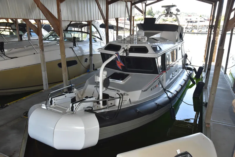 Slide: The Image of 2005 SAFE Boats 33 Full Cabin docked in a covered marina. - 5