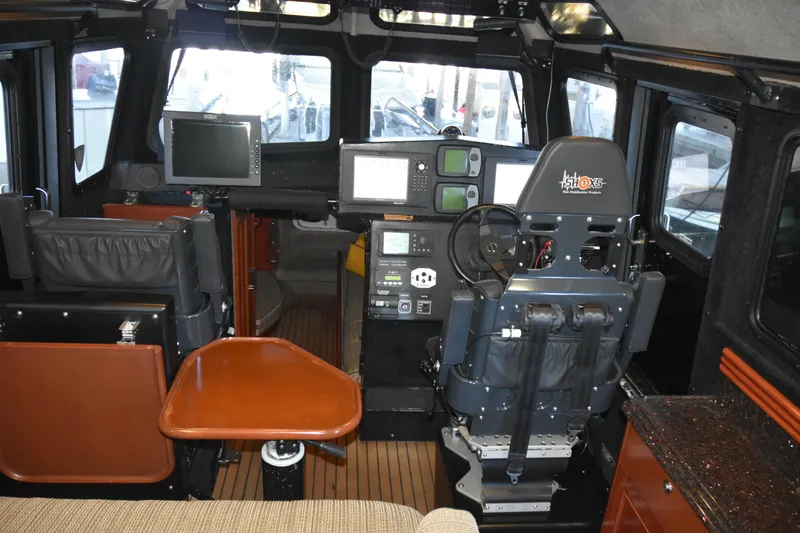 Slide: The Image of Interior of 2005 SAFE Boats 33 Full Cabin, featuring navigation equipment and seating. - 51