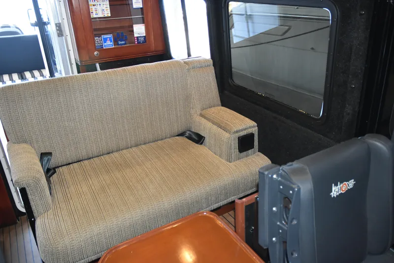 Slide: The Image of Interior of 2005 SAFE Boats 33 Full Cabin with cushioned seating and window view. - 52