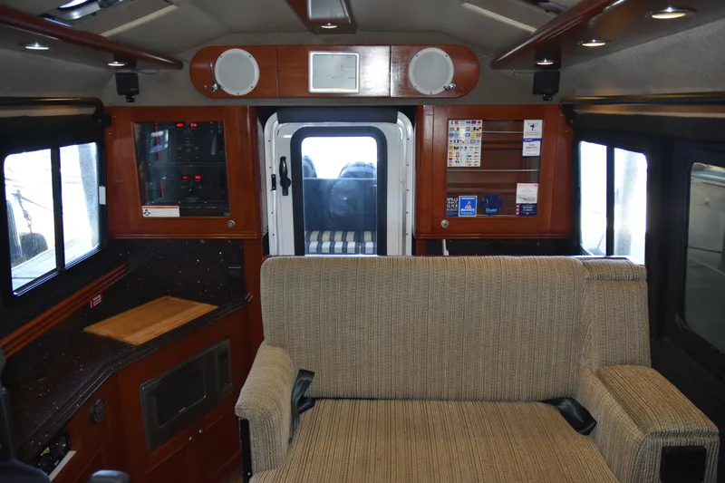 Slide: The Image of Interior of 2005 SAFE Boats 33 Full Cabin with seating and control panels. - 56
