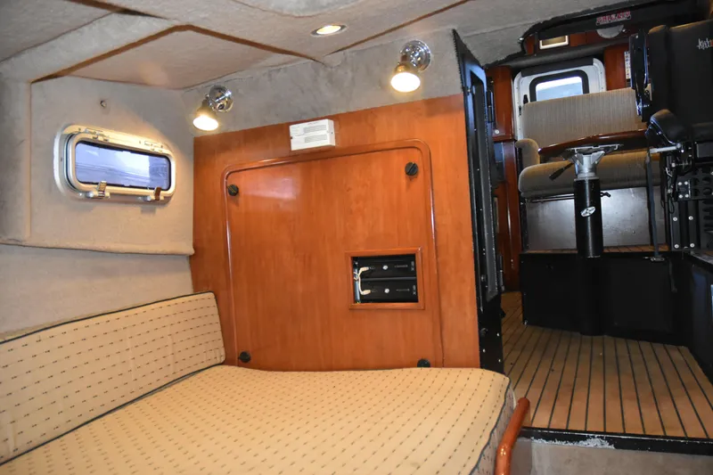 Slide: The Image of Interior of 2005 SAFE Boats 33 Full Cabin, featuring cozy seating and wooden accents. - 61