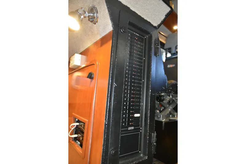 Slide: The Image of Electrical panel inside a 2005 SAFE Boats 33 Full Cabin, showcasing circuit breakers and wiring. - 64