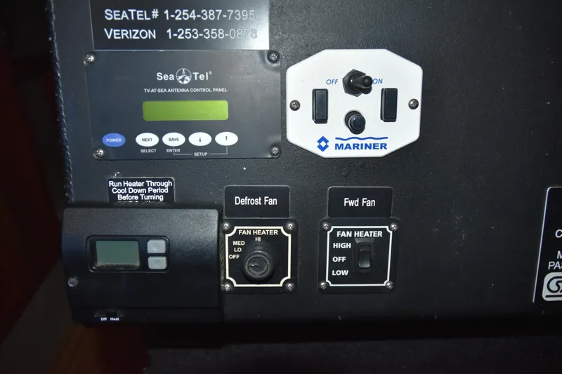 Slide: The Image of Control panel of a 2005 SAFE Boats 33 Full Cabin with Sea Tel and Mariner switches. - 69