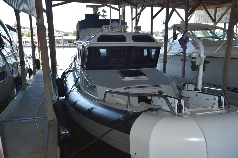 Slide: The Image of 2005 SAFE Boats 33 Full Cabin docked in a covered marina. - 7