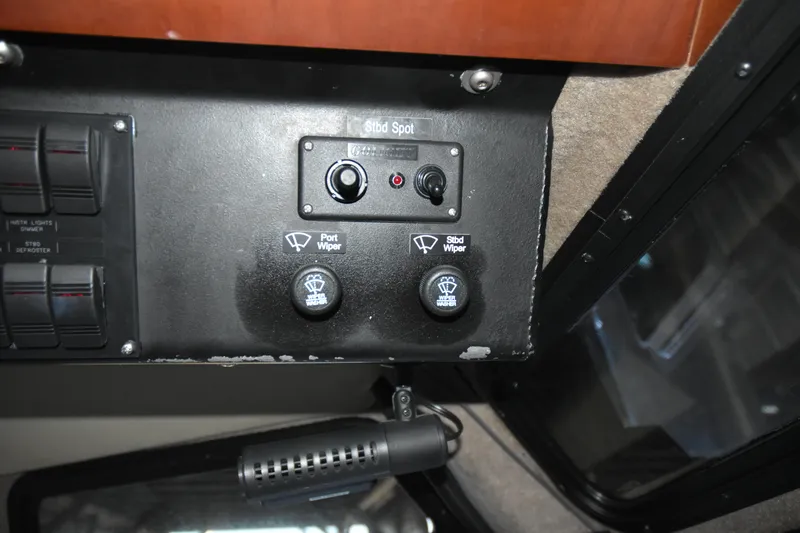 Slide: The Image of Control panel of a 2005 SAFE Boats 33 Full Cabin, featuring wiper switches. - 75