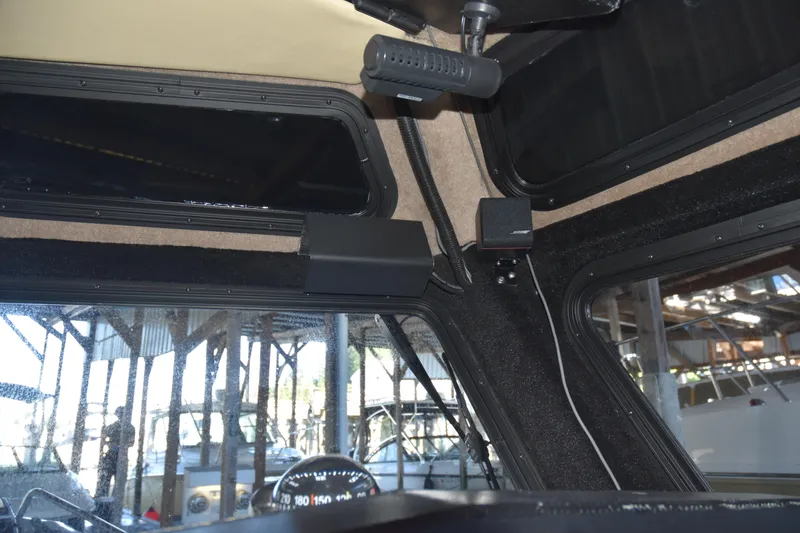 Slide: The Image of Interior view of a 2005 SAFE Boats 33 Full Cabin, showcasing dashboard and windows. - 76