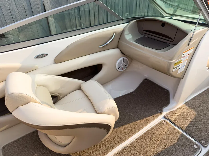 Slide: The Image of 2007 Chaparral 190 SSi boat interior with beige seating and carpeted flooring. - 11
