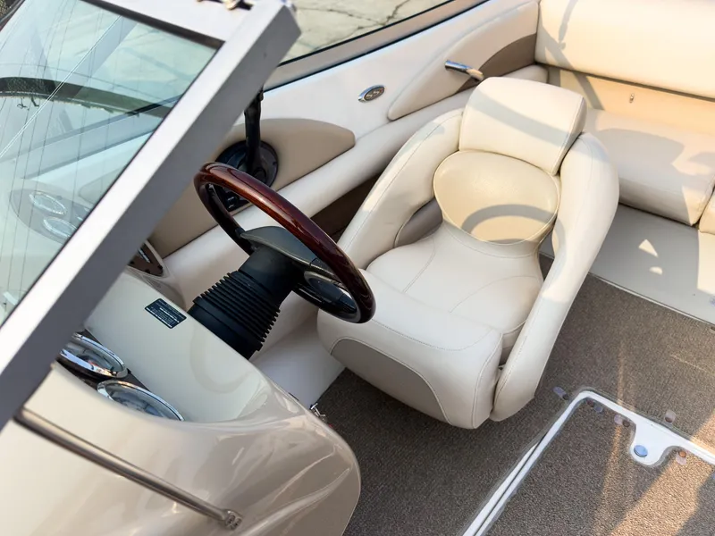 Slide: The Image of 2007 Chaparral 190 SSi boat interior with beige seating and wooden steering wheel. - 20