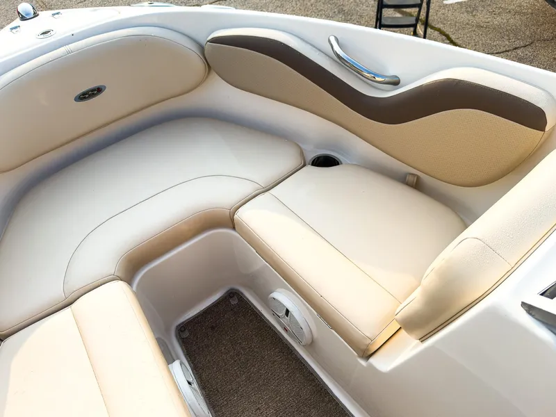 Slide: The Image of 2007 Chaparral 190 SSi boat interior with beige seating and cup holder. - 26