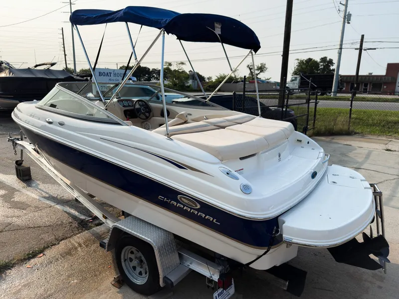 Slide: The Image of 2007 Chaparral 190 SSi boat on trailer with blue canopy, parked outdoors. - 32