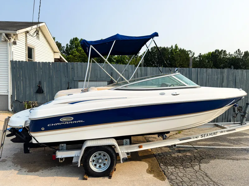 Slide: The Image of 2007 Chaparral 190 SSi boat on trailer with blue canopy, parked outdoors. - 33