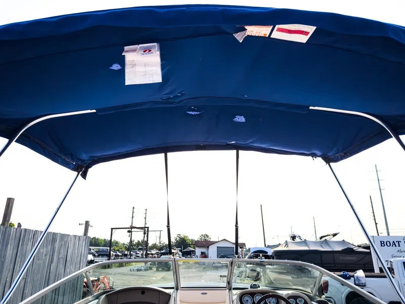Slide: The Image of 2007 Chaparral 190 SSi boat with blue canopy and dashboard view. - 34