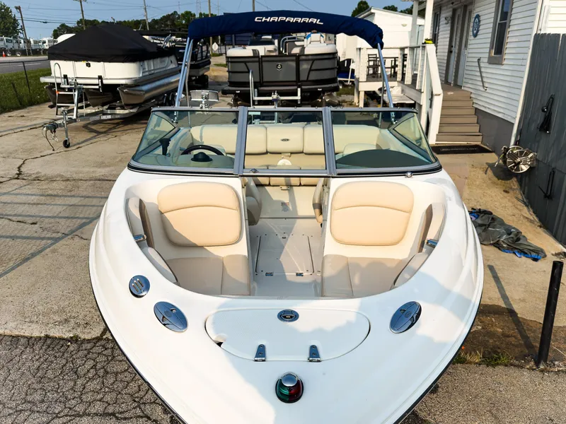 Slide: The Image of 2007 Chaparral 190 SSi boat with beige seating, docked at a marina. - 5