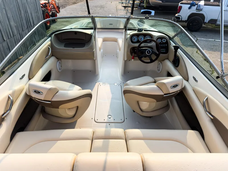 Slide: The Image of 2007 Chaparral 190 SSi boat interior with beige seating and dashboard. - 8