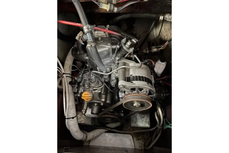 Slide: The Image of Engine of a 1970 King's Cruiser 29 sailboat, showcasing mechanical components and wiring. - 12