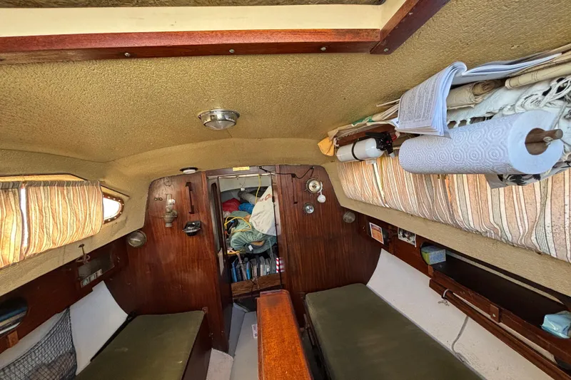 Slide: The Image of Interior of a 1970 King's Cruiser 28 sailboat with cozy cabin and storage. - 17