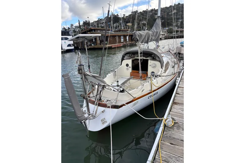 Slide: The Image of 1970 King's Cruiser 29 sailboat docked in a marina, featuring classic design and rigging. - 3