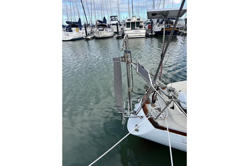 Slide: The Image of King's Cruiser 29 sailboat from 1970 docked in a marina with other boats. - 7