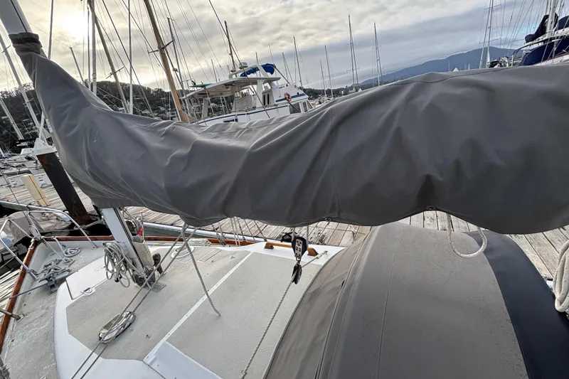 Slide: The Image of 1970 King's Cruiser 29 sailboat docked at marina with covered boom. - 8