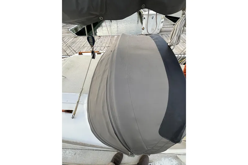 Slide: The Image of 1970 King's Cruiser 29 sailboat deck with covered equipment, dockside view. - 9