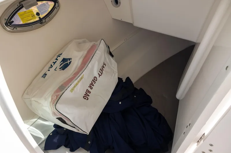 Slide: The Image of Safety gear bag inside 2019 Robalo R317 Dual Console boat storage compartment. - 12