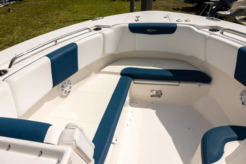 Slide: The Image of 2019 Robalo R317 Dual Console boat interior with blue and white seating. - 13