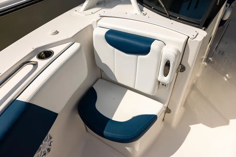 Slide: The Image of 2019 Robalo R317 Dual Console boat seat with blue and white upholstery. - 14