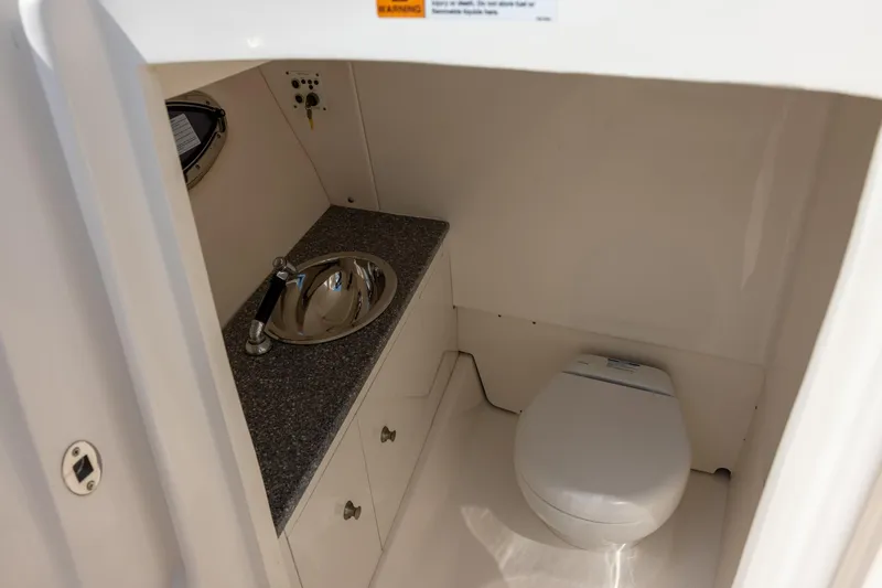 Slide: The Image of 2019 Robalo R317 Dual Console boat bathroom with sink and toilet. - 15