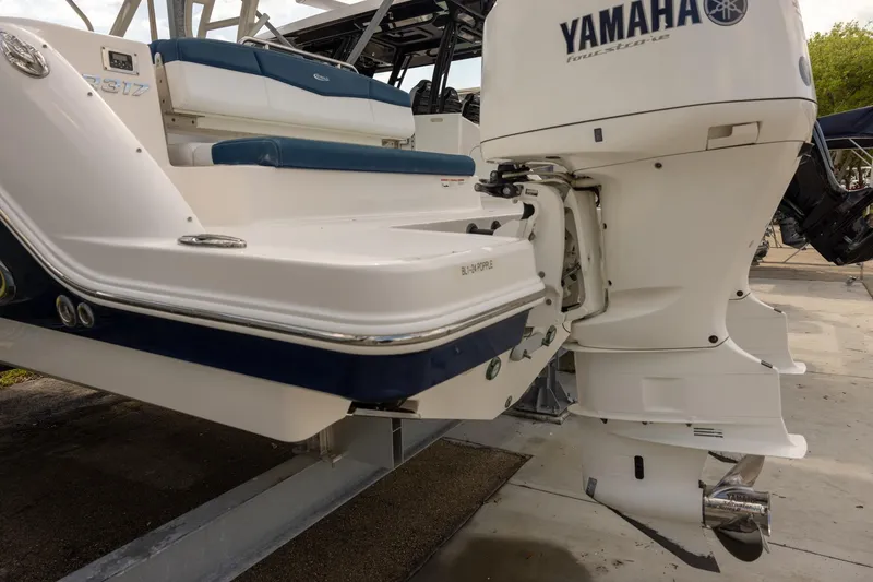 Slide: The Image of 2019 Robalo R317 Dual Console boat with Yamaha outboard motor, docked on a trailer. - 19