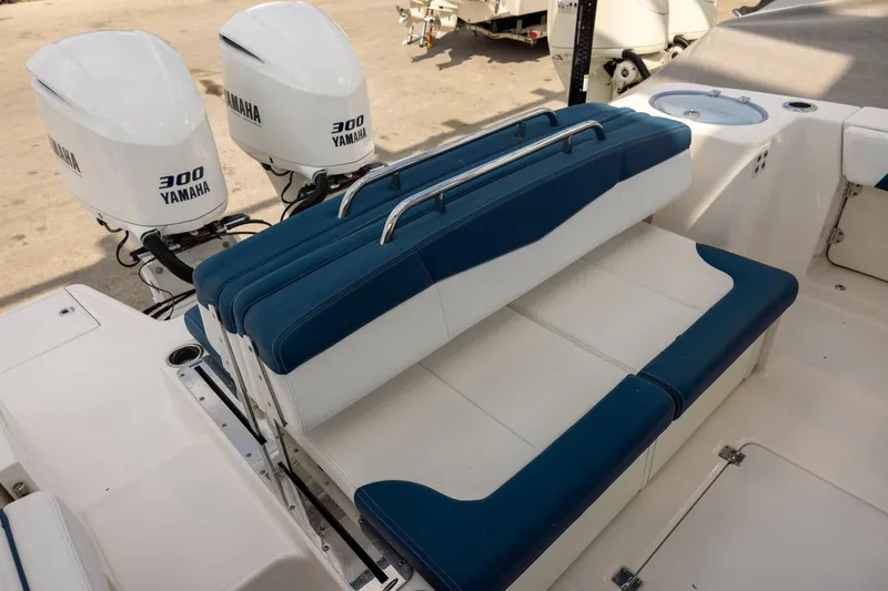 Slide: The Image of 2019 Robalo R317 Dual Console boat with Yamaha 300 engines and blue seating. - 5